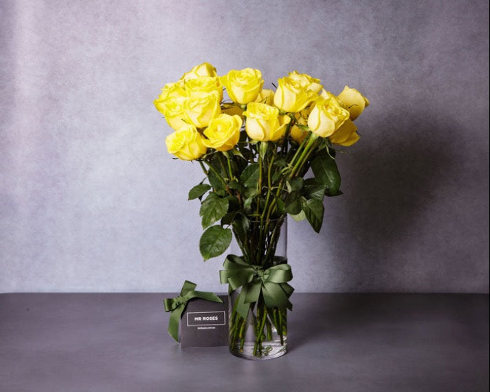 long stemmed yellow roses in a vase