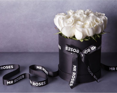 fresh white roses in stylish mr roses hat box