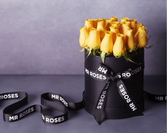 fresh yellow roses in stylish mr roses hat box