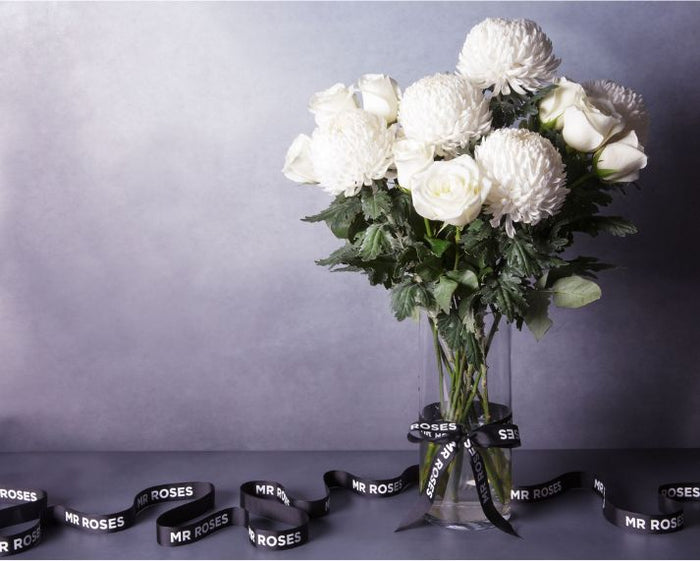 white chrysanthemum and white roses floral arrangement