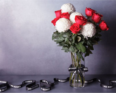 white chrysanthemum and red roses flower arrangement in vase