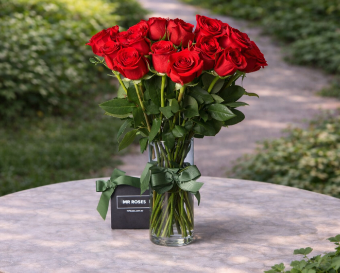 medium stemmed red roses in a vase