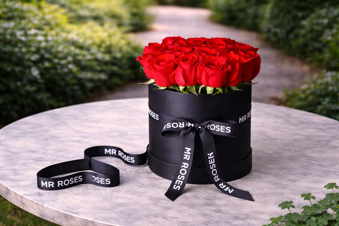 fresh red roses in an elegant black hat box