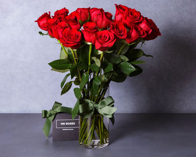 medium stemmed red roses in a vase