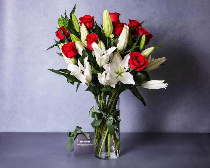 Fragrant white lilies and red roses flower arrangement
